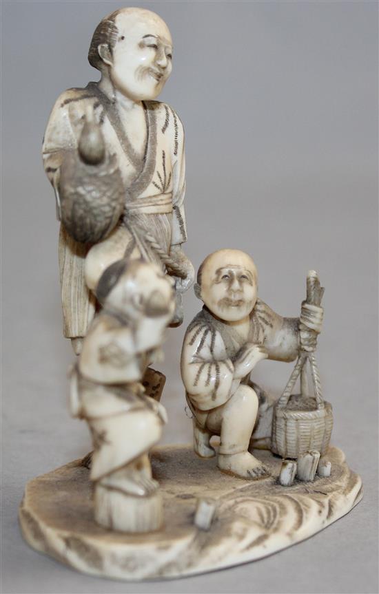 A Japanese carved ivory okimono group of street vendors, Meiji period,(-)